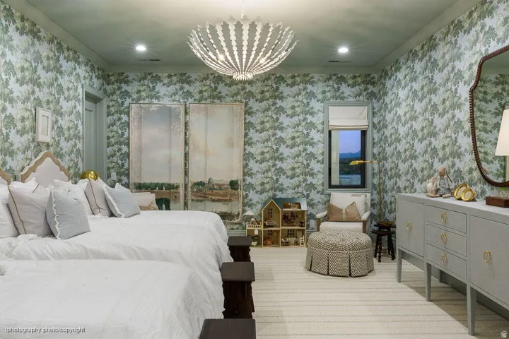 Patterned wallpaper throughout, with a decorative chandelier and recessed lighting