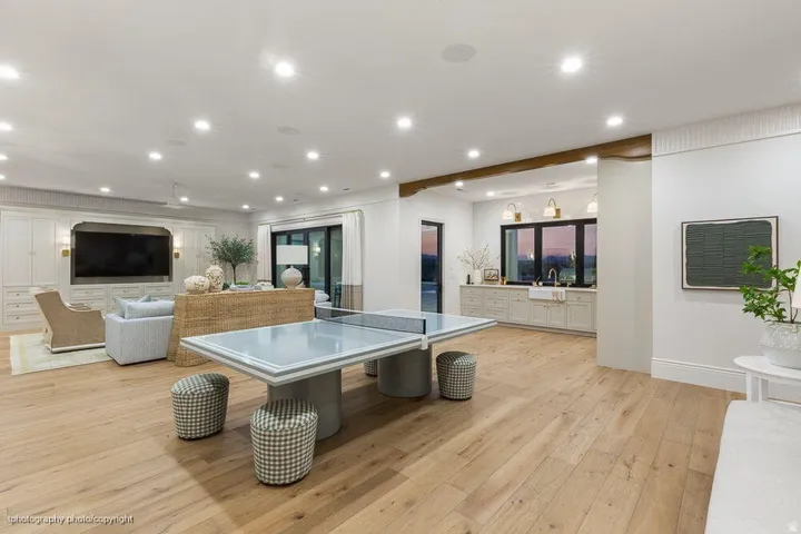 Expansive light wood-finish flooring throughout