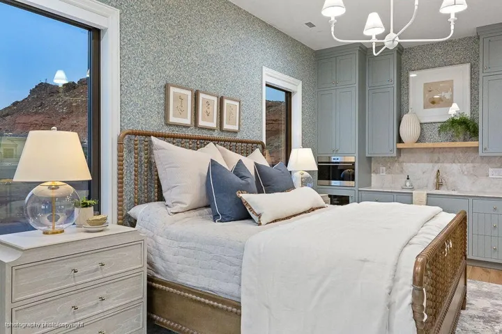 Built-in cabinetry with integrated microwave, wall-mounted faucet, and window with natural scenery
