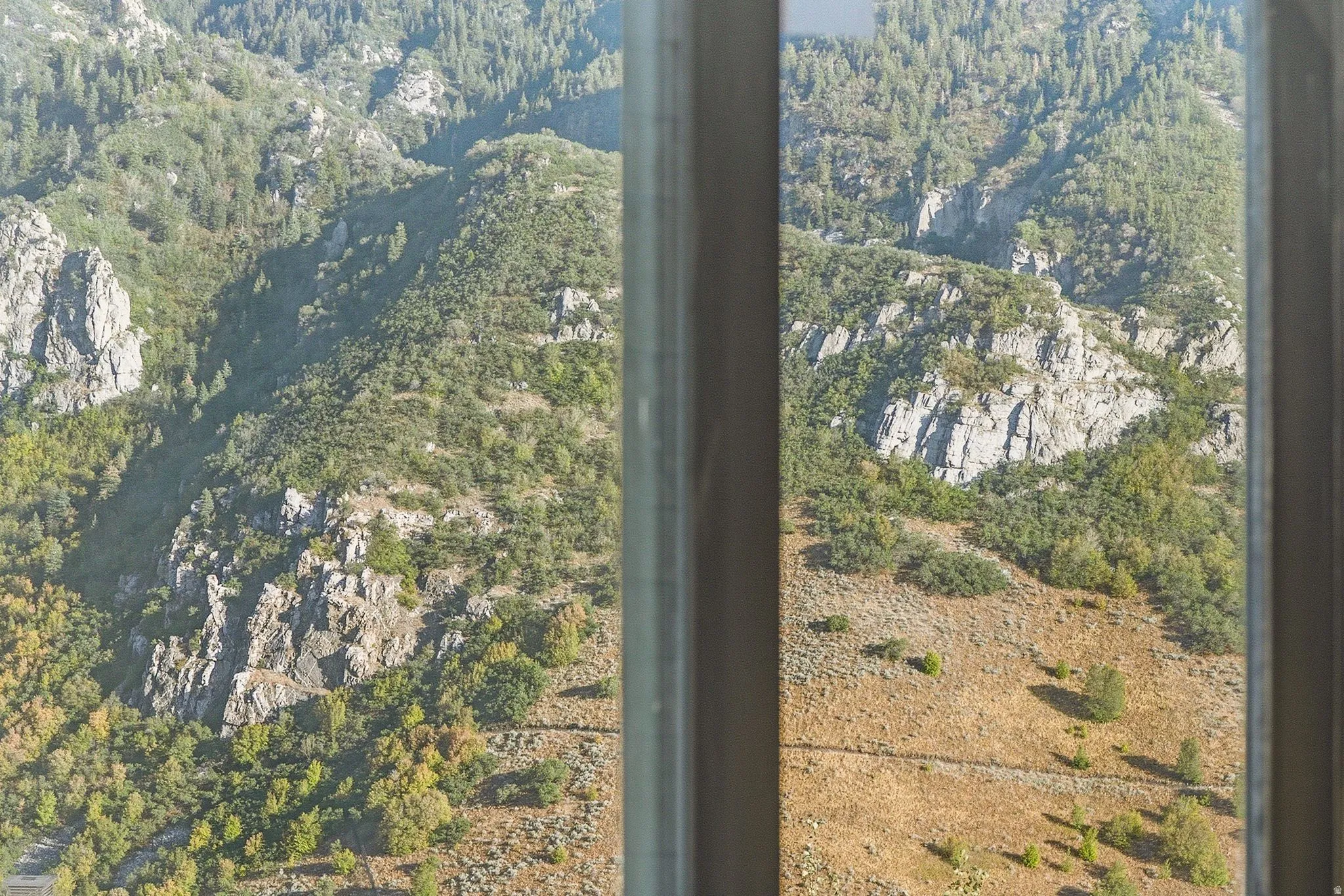 Panoramic mountain landscape visible through a window frame