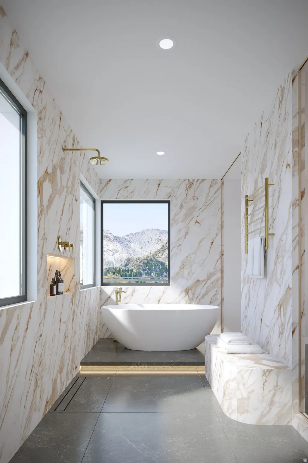 Freestanding soaking tub with mountain scenery, floor-to-ceiling marble-finish wall paneling, recessed wall niche, and large format floor tiling