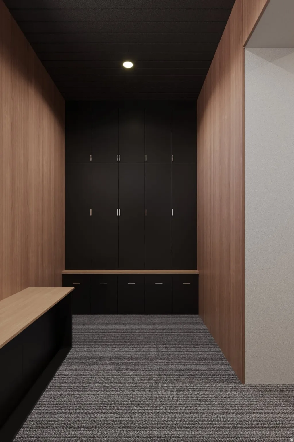 Wood-paneled walls, built-in black cabinetry with metal hardware, light wood-finish countertops, recessed lighting, and striped carpet flooring