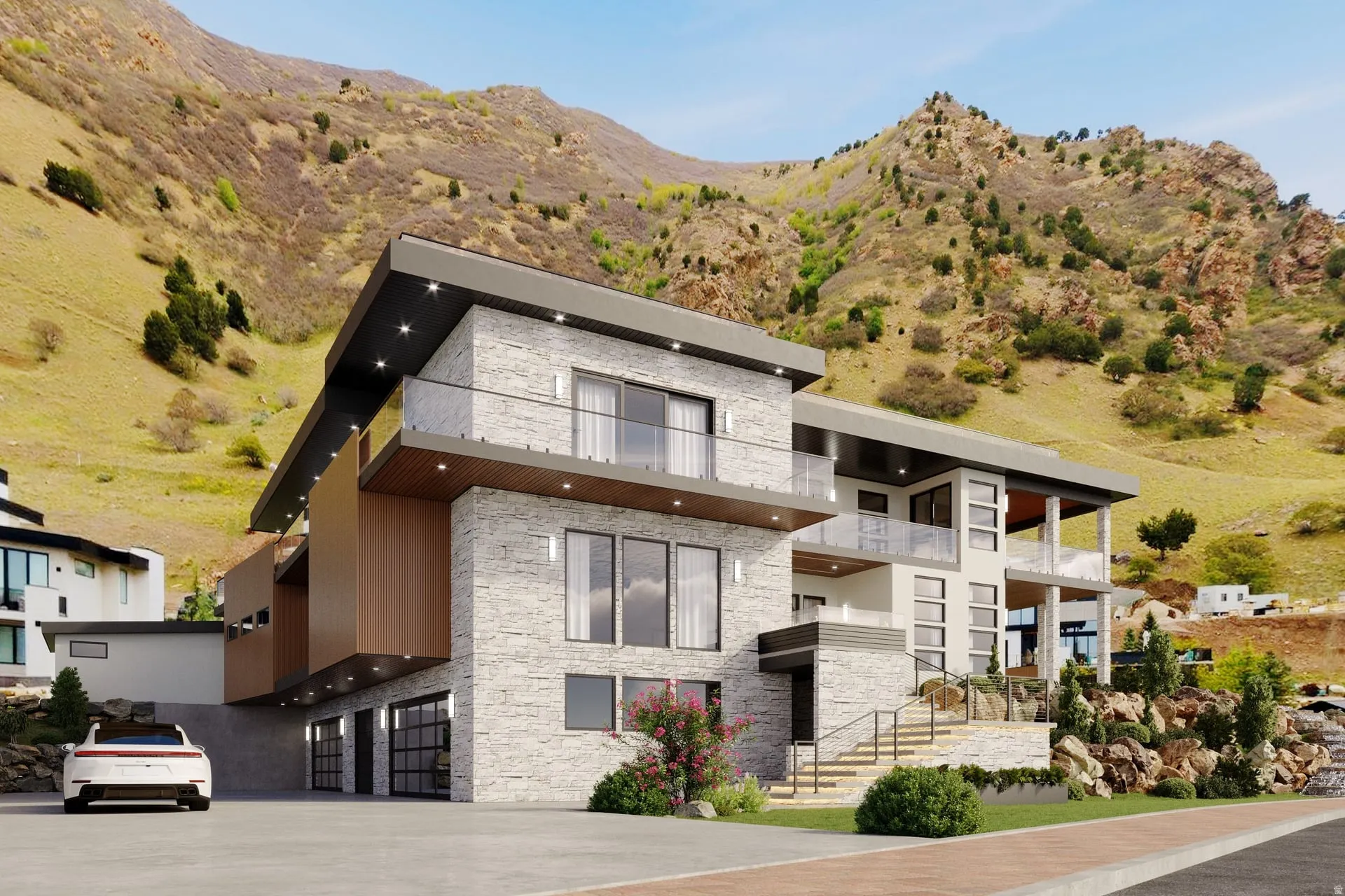 Modern architecture featuring stone and wood-finish paneling, glass balcony railings, a two-car garage, and a prominent mountain backdrop