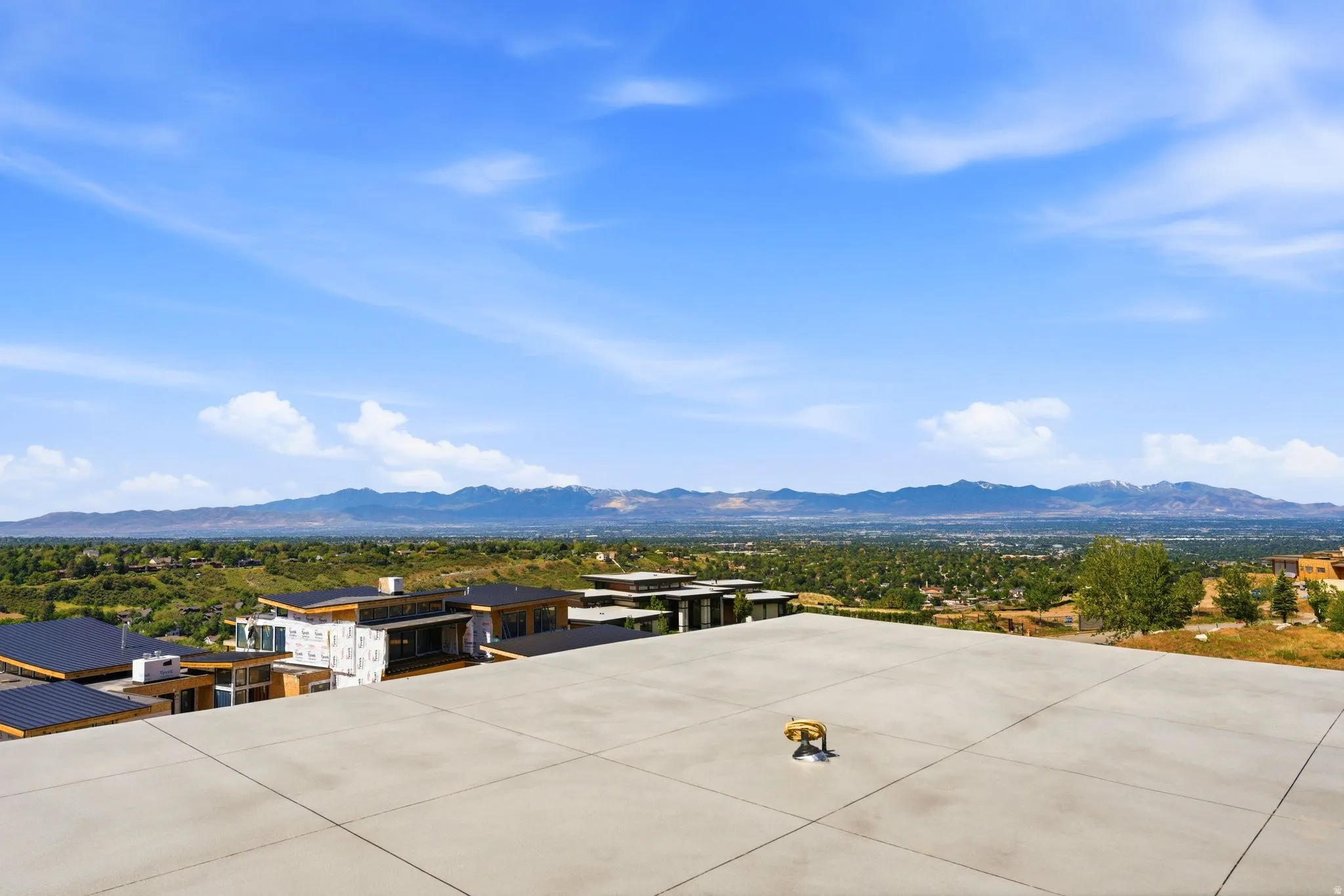 Expansive outdoor deck with mountain and valley scenery