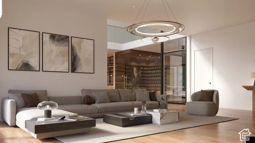 Spacious living area featuring wood-finish flooring, a modern chandelier, and a glass-enclosed wine display