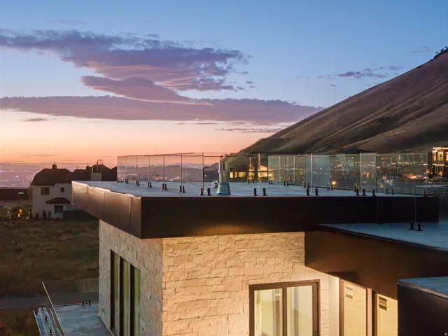 Stone exterior with expansive glass railing rooftop deck