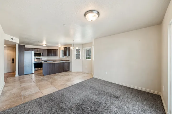 Kitchen featuring dark wood-finish cabinetry, stainless steel appliances, and stone-finish countertops