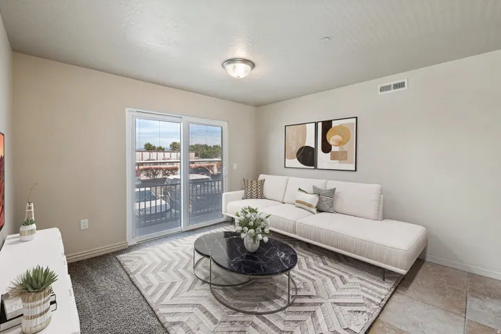 Sliding glass door to balcony, neutral wall paint, flush mount ceiling light, and mixed flooring with carpet and tile. *Virtually staged photo.