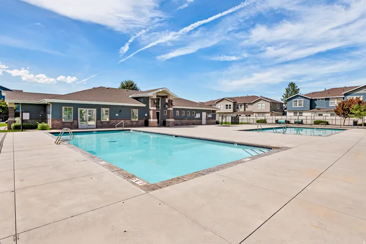 Expansive concrete pool deck with swimming poolsand hot tubs