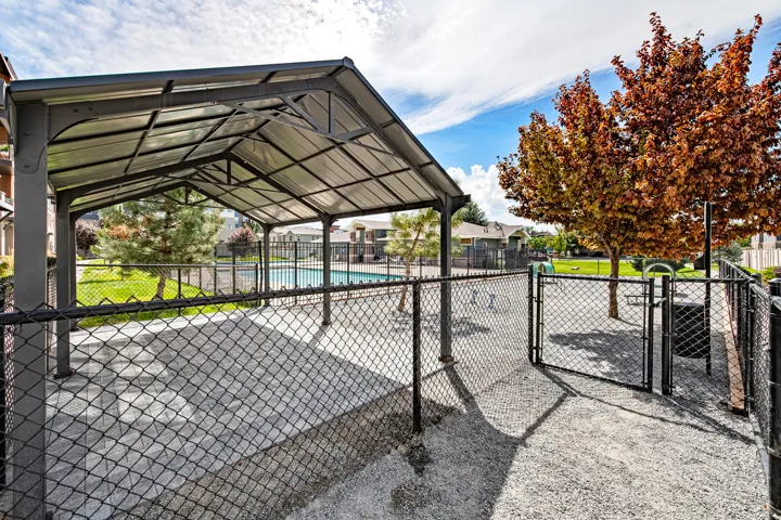 Shaded outdoor structure with a chain-link fence enclosure