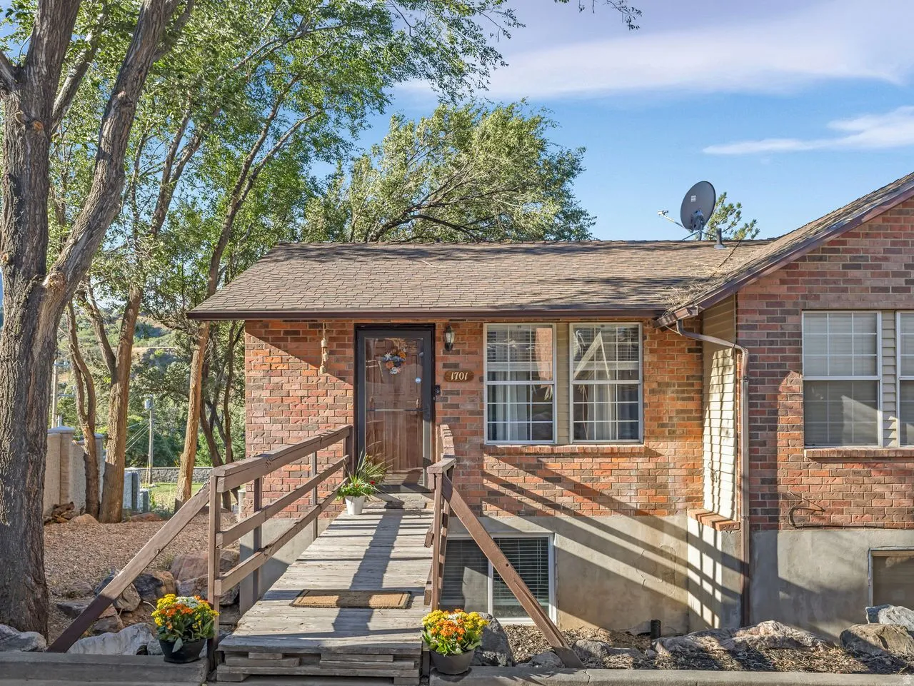 Brick exterior with a gabled roof and covered entry