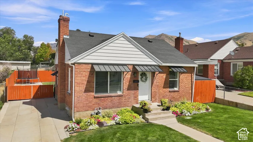 Brick exterior with a gabled roof and white siding