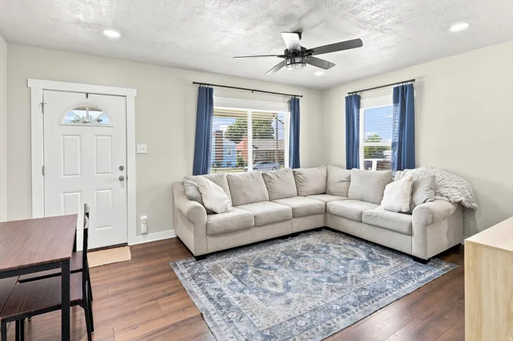 Wood-finish flooring, recessed lighting, and a ceiling fan with integrated light