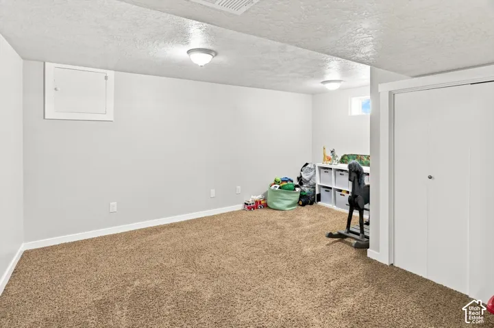 Carpeted room with white walls, recessed lighting, and a bi-fold closet