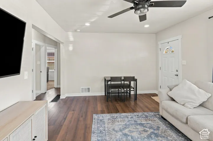 Wood-finish flooring throughout, recessed lighting, and a ceiling fan with integrated light