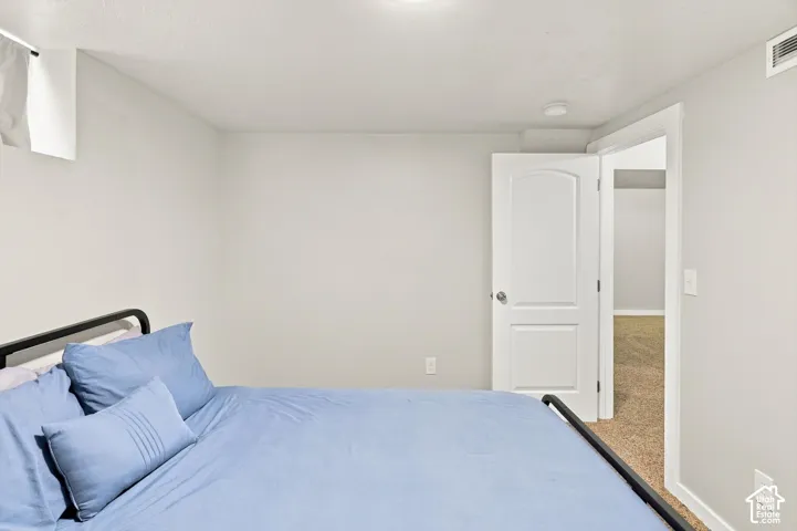 Neutral wall paint, recessed lighting, white interior door, and carpeted flooring