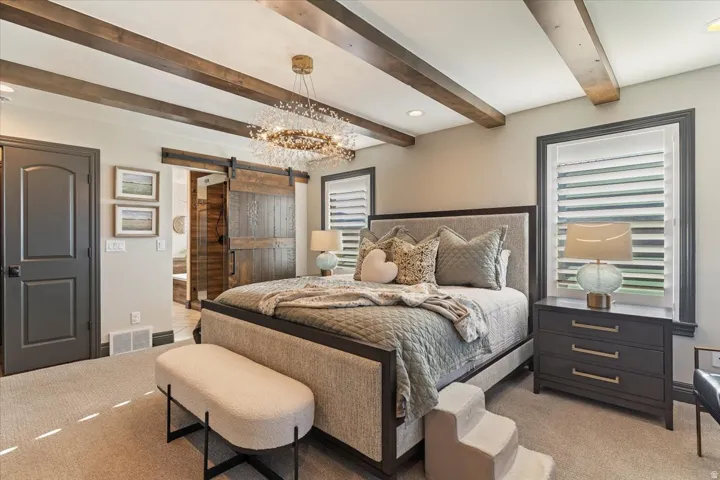 Wood-beamed ceiling with a brass-finish chandelier