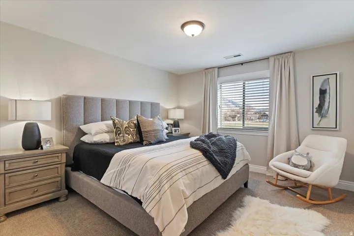 Recessed window with blinds, wall-to-wall carpeting, and a flush mount ceiling light fixture