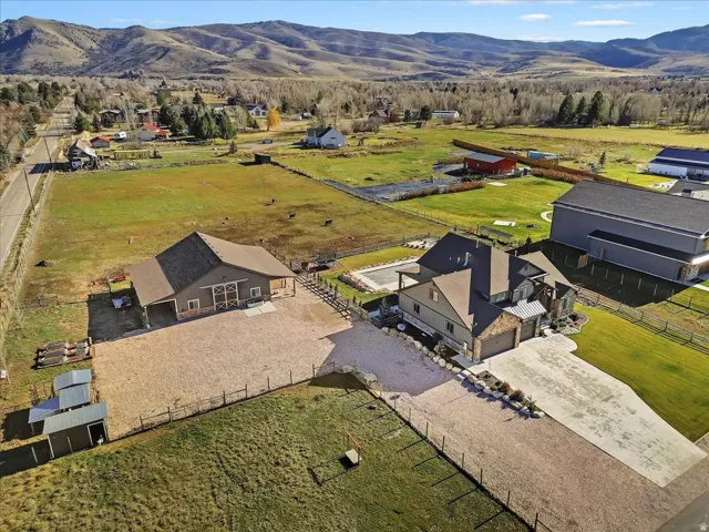 Expansive property with a multi-level main residence, detached barn structure, and an in-ground pool