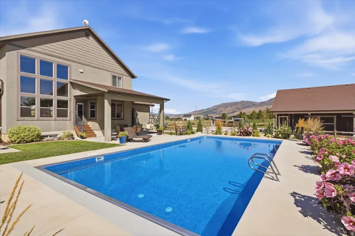 Rectangular inground swimming pool with integrated steps and concrete surround