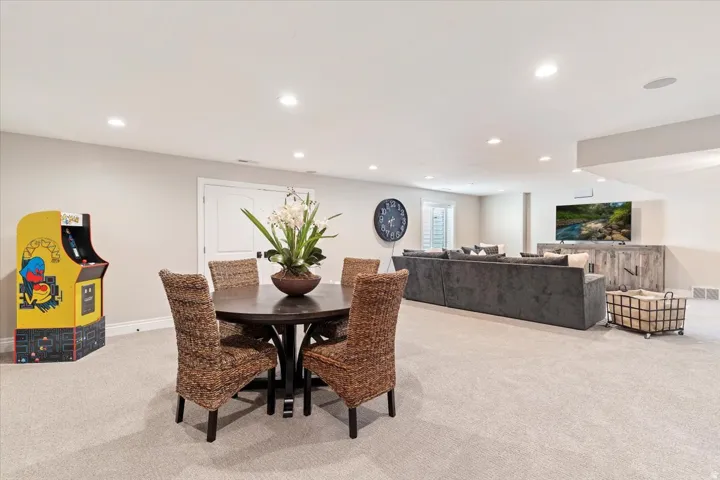 Recessed ceiling lighting, carpeted flooring, and a window with white shutters