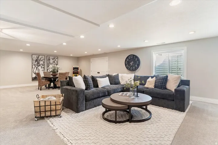 Recessed lighting, large area rug, neutral wall color, double doors, and window with blinds