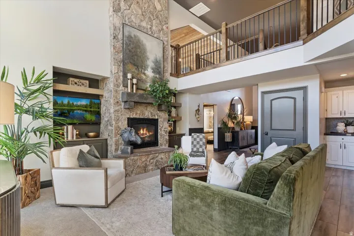 Soaring ceiling with a stone-clad fireplace and hearth