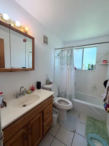 Wood-finish vanity with an integrated sink and chrome faucet