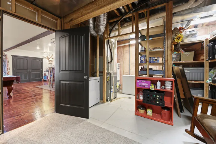 Finished interior space with wood-finish flooring, recessed lighting, and dark paneled doors