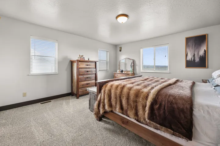 Recessed lighting and ceiling-mounted light fixture illuminate the room