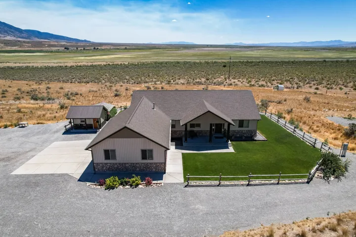 Single-story residence featuring a stone and siding exterior, a gabled roofline, and an attached garage