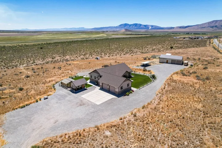 Spacious property with a two-car garage, a separate detached garage, and an additional smaller outbuilding