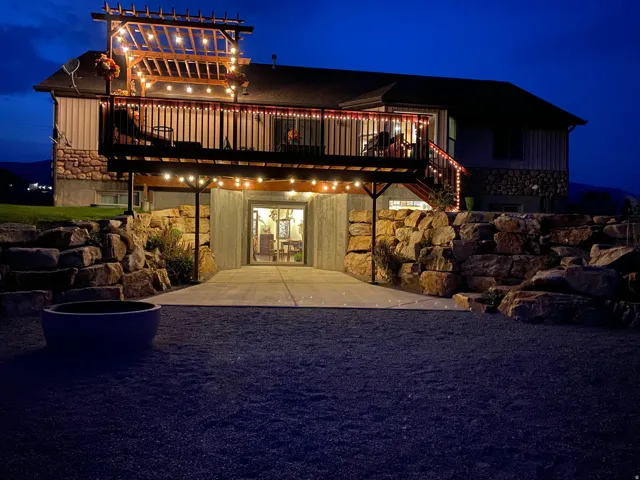 Spacious elevated deck with pergola and string lights