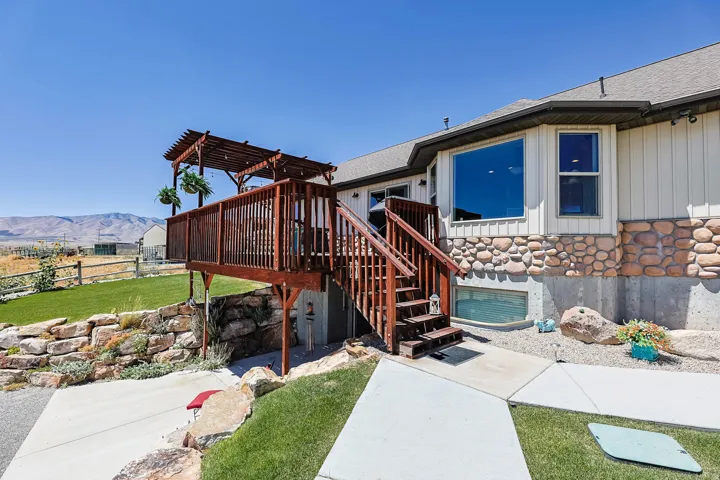 Multi-level rear deck with a pergola, offering outdoor living space