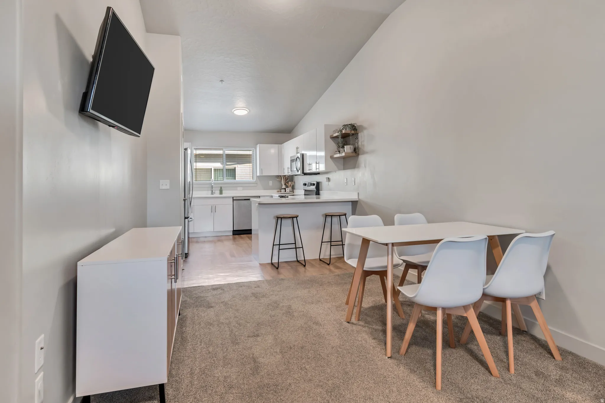 Kitchen featuring white cabinetry, stainless steel appliances, and a light-toned countertop