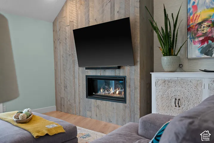 Wood-paneled accent wall featuring a built-in fireplace