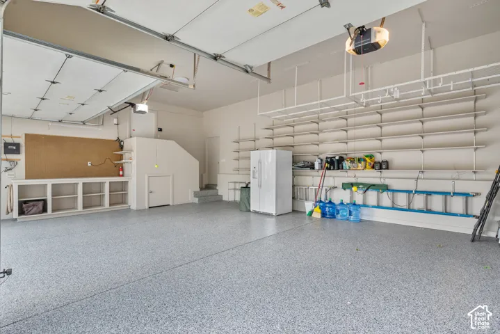 Epoxy-coated flooring, built-in shelving, integrated workbench, and a dedicated storage area