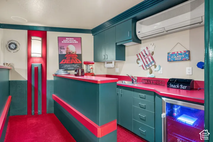 Built-in cabinetry with red countertops, integrated sink, and an under-counter refrigerator