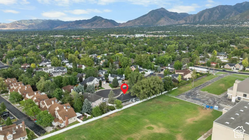 Expansive suburban setting with mature trees and mountain scenery