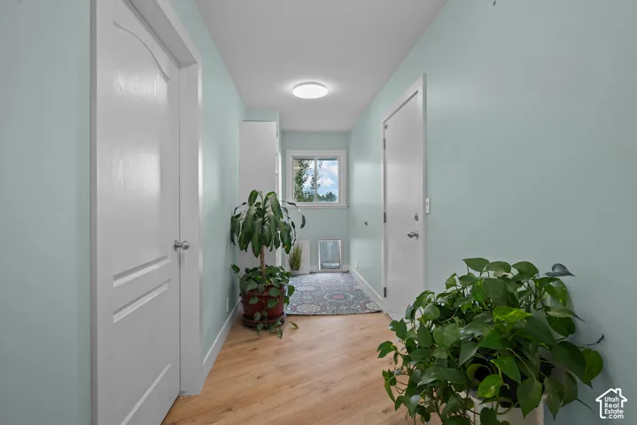 Light wood-finish flooring, light blue walls, and a recessed ceiling light