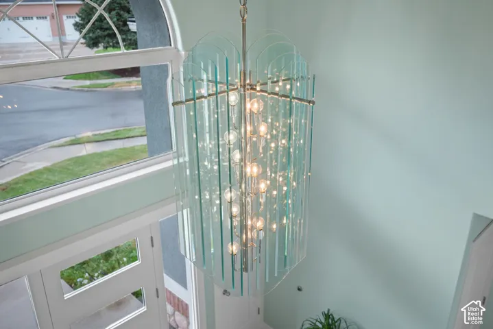 Two-story entry with an arched window and a decorative chandelier