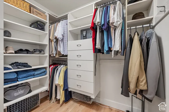 Custom closet system featuring multiple hanging rods, built-in shelving, and drawers