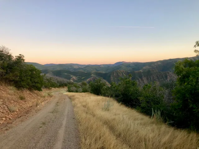 Expansive natural landscape with rolling hills and distant mountains