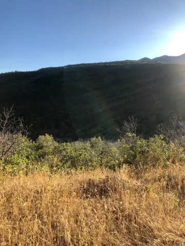 Expansive natural landscape featuring varied terrain and distant mountains