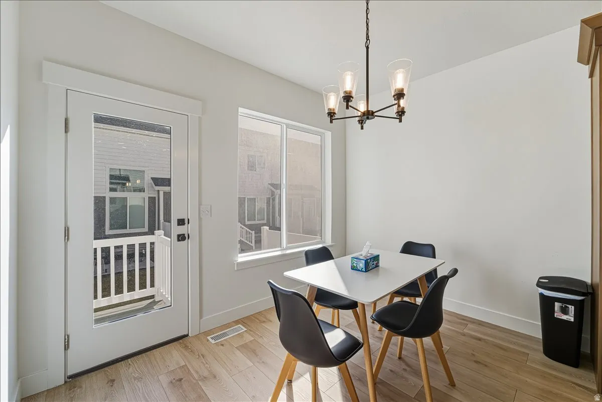 Wood-finish flooring, white walls, and a glass-paneled exterior door