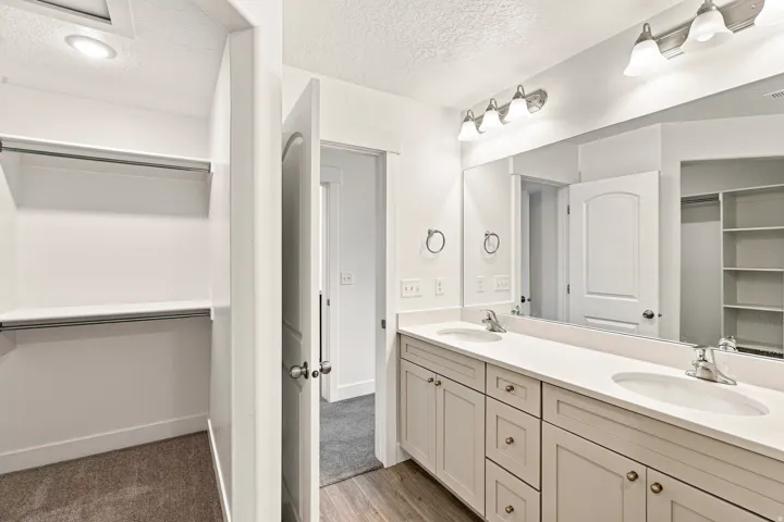 Dual vanity with white countertops, undermount sinks, and brushed nickel fixtures