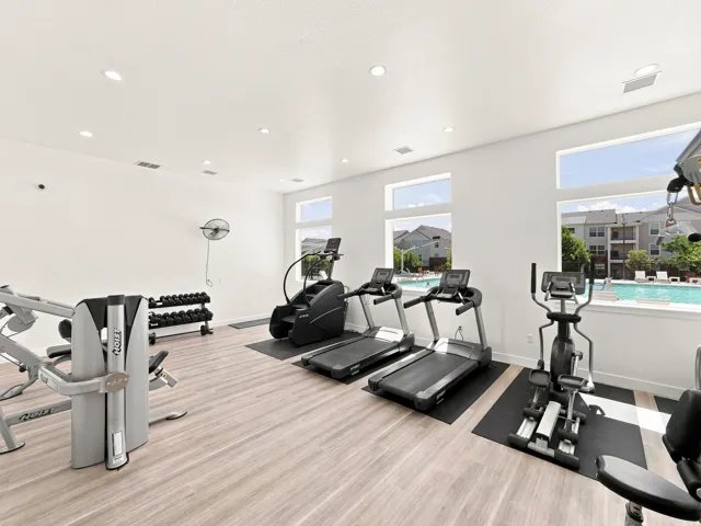 Fitness center featuring wood-finish flooring, recessed lighting, and expansive windows