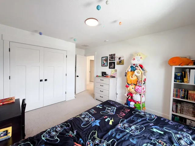White interior doors with black hardware, recessed lighting, and light-toned carpeting