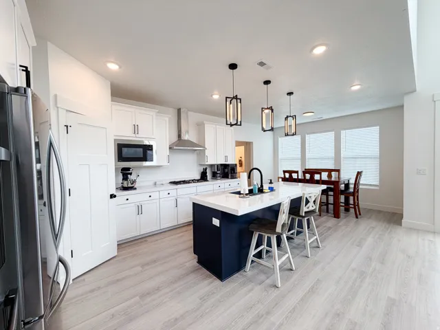Modern kitchen with white cabinetry and stainless steel appliances
