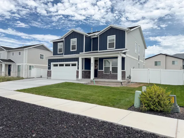 Two-story exterior with dark blue siding and light gray accents